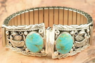 Genuine Turquoise Mountain Mine Turquoise set in Sterling Silver. The Turquoise Mountain Mine is located in the Mineral Park Mining District, Mohave County, Arizona. Although Turquoise Mountain is located near the Kingman Turquoise Mine it is considered a classic mine in its own right because the Turquoise is so different in appearance. It is also known as "Old Man Turquoise". Beautiful Sterling Silver Eagle Design. Mens Watch Tips with expandable band.  Created by Navajo Artist Thomas Chischilly.