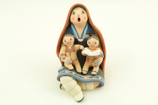 Storyteller Pottery by Mary R. Lucero from the Jemez Pueblo. Mary R. Lucero is a full blooded Native American Indian. She was born into the Jemez Pueblo in 1948. Mary was inspired to learn the art of working with clay by her Grandmother, Magnita Lucero. Magnita introduced Mary to the hills that provided the best clay. Then, Mary gathers other natural pigments from the sacred grounds within the Jemez pueblo. Magnita taught Mary how to mix, shape, paint, and fire pottery the traditional way, outdoors. She began hand coiling her pottery at the age of 14, when she would watch her grandmother make her pottery the traditional way.

Mary specializes in the handmade pueblo styled storytellers, but does not limit her abilities. She also makes animals, nativity�s and other clay sculptures. Mary uses natural colors to paint her pottery. Mary signs her pottery.

Mary is related to the following artists: Carol Gachupin (sister), Mary I. Lucero (cousin), Diane Lucero, and Joyce Lucero (daughters).

Awards:

-1999 New Mexico State Fair 4th Place 
-Jemez Red Rock Art Show 2nd place

Publications:

-Southwestern Pueblo Pottery 2,000 Artist Biographies 
-Southwestern Pottery Anasazi to Zuni
