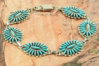 Stunning Bracelet featuring Genuine Sleeping Beauty Turquoise set in Sterling Silver. Beautiful Needle Point Design. The Sleeping Beauty Turquoise mine is located in Gila County, Arizona. Created by Zuni Artist Fritzon Qualeon. Signed by the artist. The Zuni Pueblo is located in New Mexico, Land of Enchantment.
