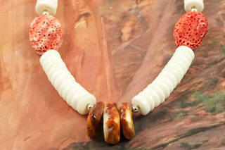 Stunning Necklace featuring Genuine White Clam Shell Rondelle Beads. The center Spiny Oyster Shell beads represent corn.  Pretty Sponge Coral Accents with Sterling Silver Beads and Clasp. Created by Santo Domingo Artist Carol Pacheco. The Santo Domingo Pueblo is in New Mexico, near Santa Fe. 
