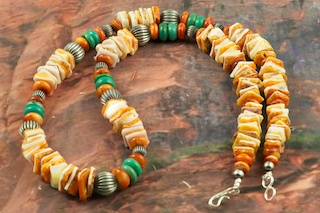 Beautiful Necklace featuring Genuine Spiny Oyster Shell with accents of Turquoise and Apple Coral. Sterling Silver Fluted Beads and Clasp. Created by Navajo Artist Petra Vandever.  The Navajo people believe that shells offer them protection.  
