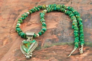 Stunning Pendant and Necklace Set featuring Genuine Manassa Turquoise set in Sterling Silver. This Turquoise is also referred to as King�s Manassa Turquoise. The Manassa Turquoise mine is located in Manassa, Conejos County, Colorado. Created by Navajo Artist Lucy Valencia. Signed L. J. by the artist.