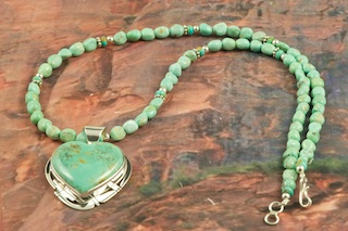 Stunning Pendant and Necklace Set featuring Genuine Manassa Turquoise set in Sterling Silver. This Turquoise is also referred to as King�s Manassa Turquoise. The Manassa Turquoise mine is located in Manassa, Conejos County, Colorado. Created by Navajo Artist Phillip Sanchez. Signed by the artist.